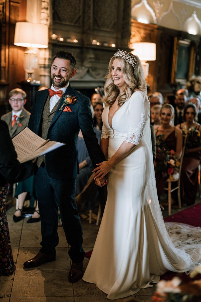 A ceremony in the great hall at Tissington Hall wedding venue, Derbyshire.